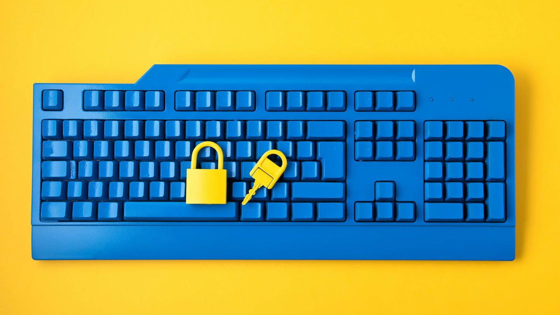 Cyber ​​data and information security idea. Yellow padlock and key and blue keyboard. computer